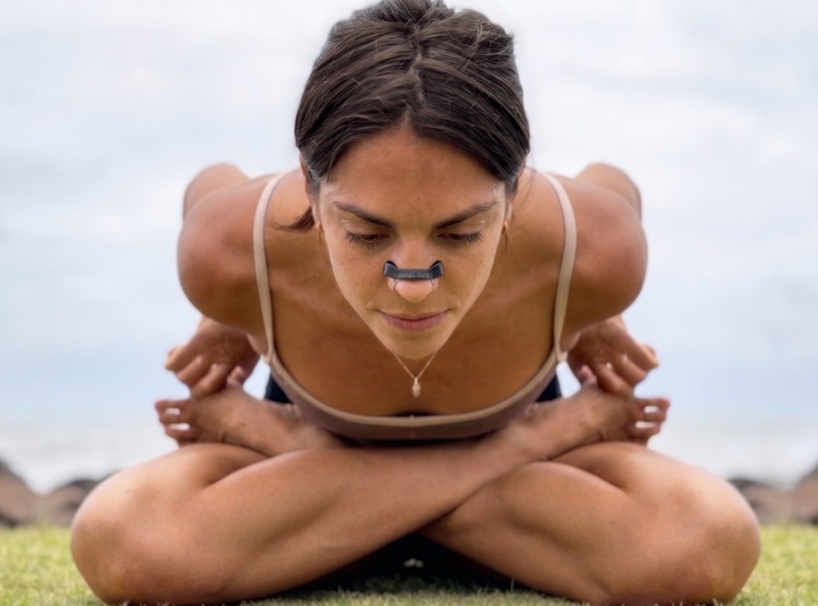 A woman doing yoga outdoors while wearing the Airlift nasal clip