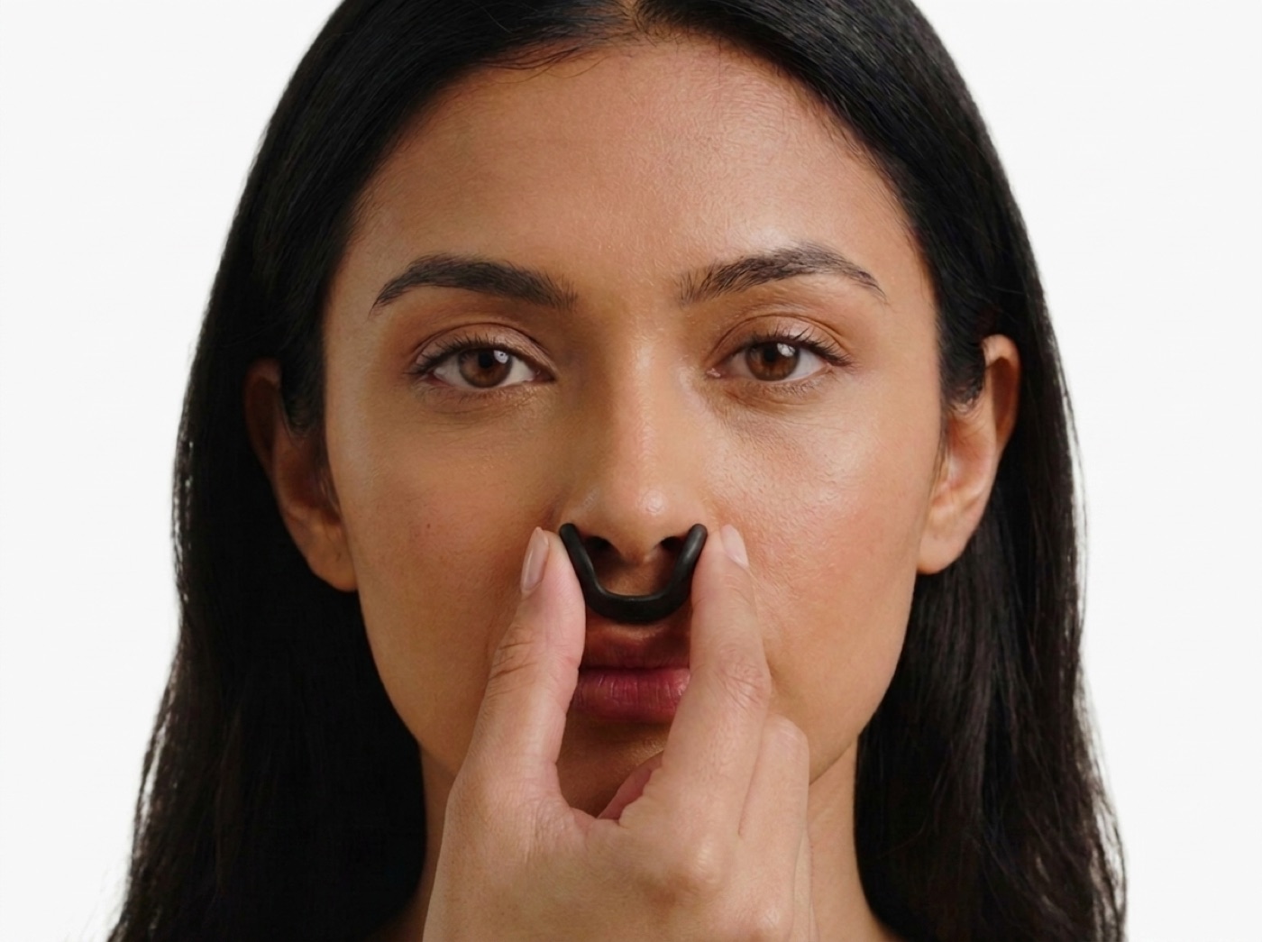 A clip held to the nose that is too small: the wings press into the sides of the nostrils
